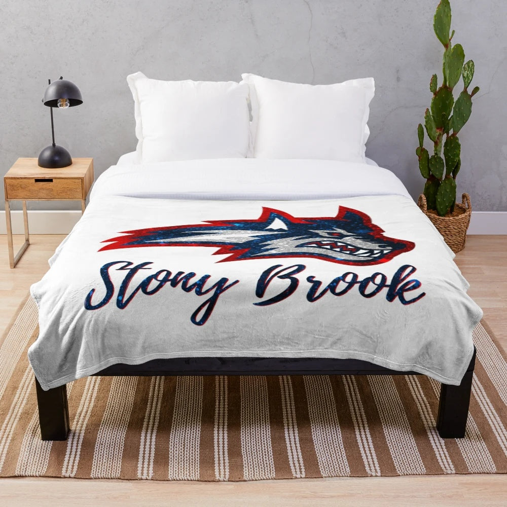 Glittering plush blanket with Stony Brook University design and Wolfie the Seawolf mascot