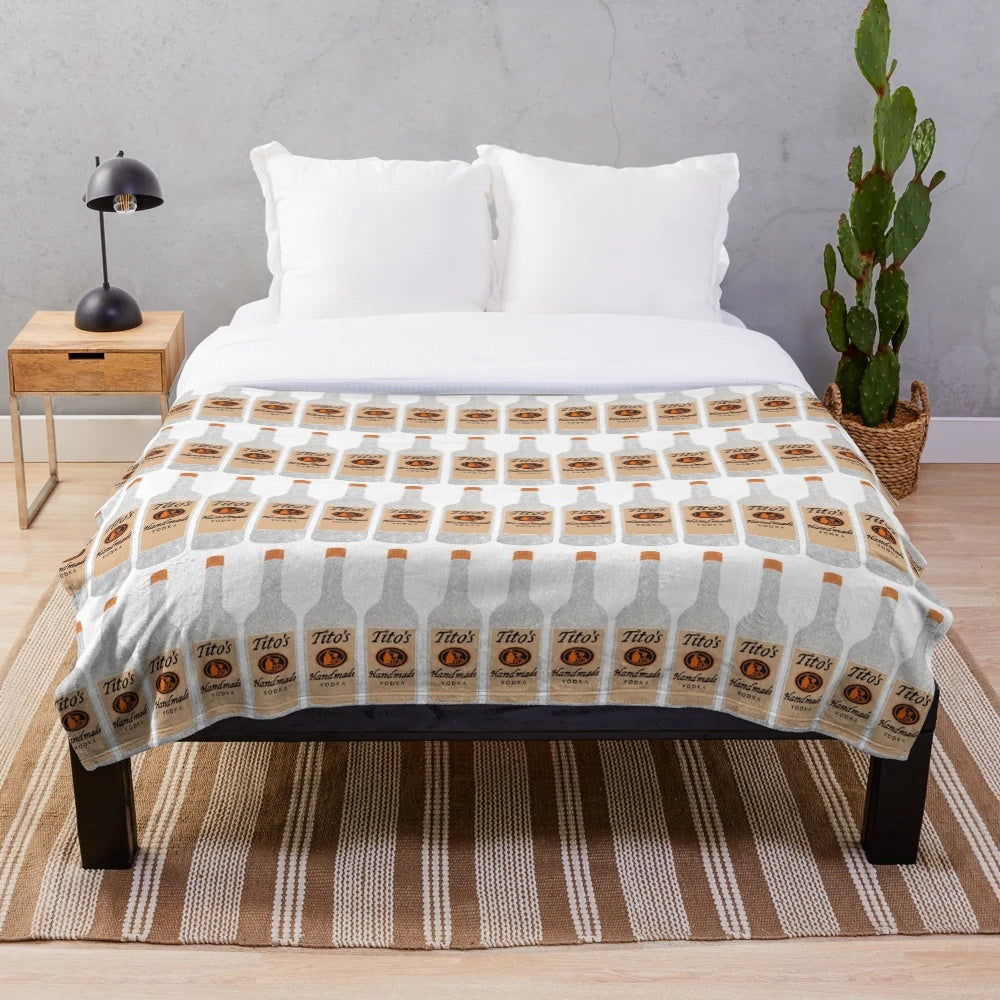 Glittering plush blanket with Tito's vodka inspired design