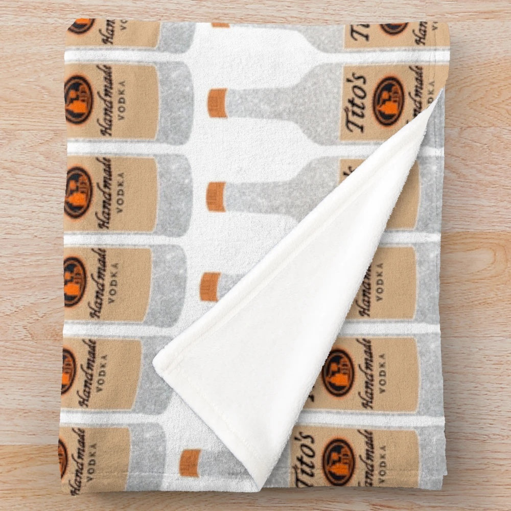 Glittering plush blanket with Tito's vodka inspired design