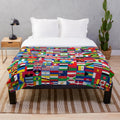 Plush blanket featuring a vibrant world flags design