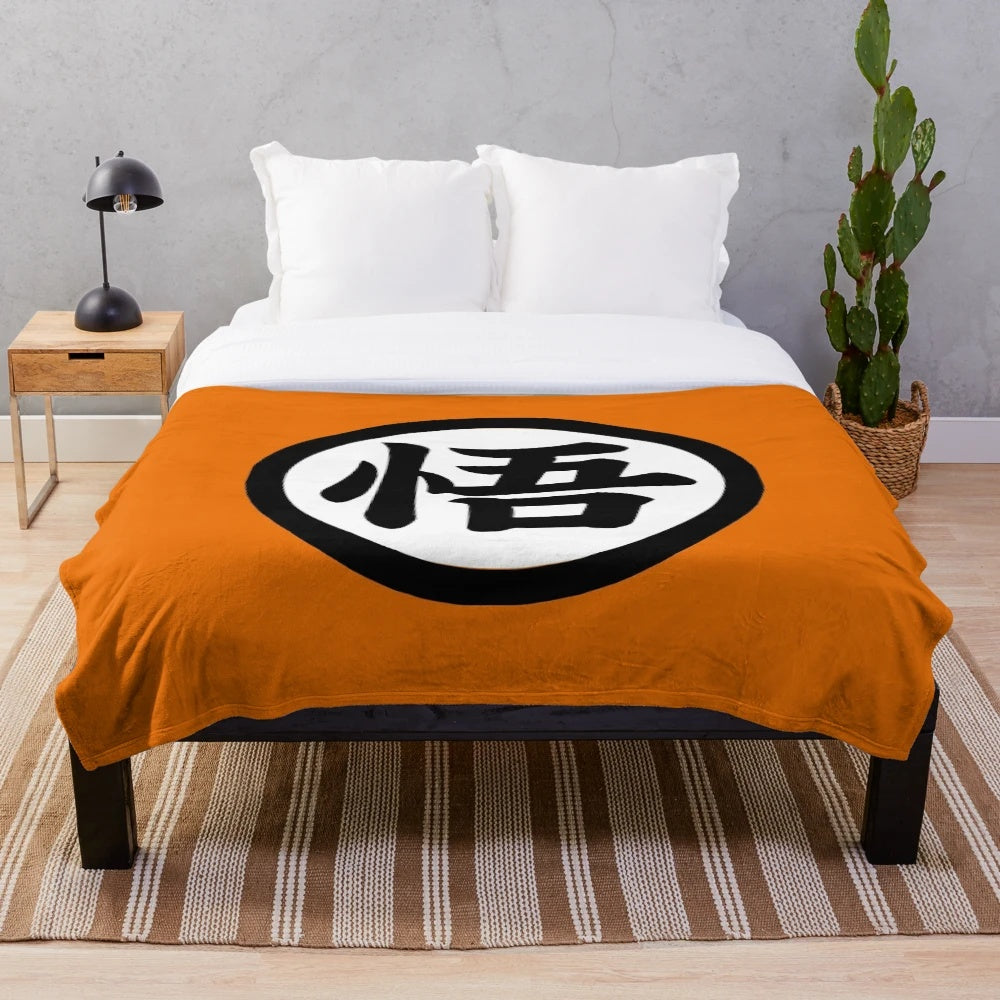 Goku's Dragon Ball inspired plush blanket with iconic saiyan symbol