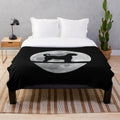 Cozy goldendoodle plush blanket featuring a goldendoodle silhouette in front of the night moon