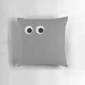Vibrant, colorful googly eyes pillow with a whimsical cartoon design