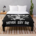 Goonies-themed plush blanket with movie characters and symbols