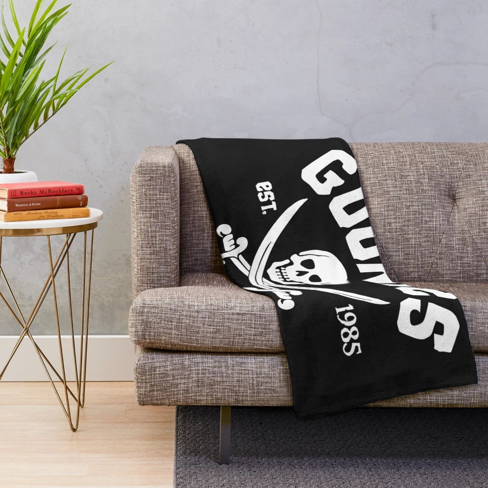 Goonies-themed plush blanket with movie characters and symbols