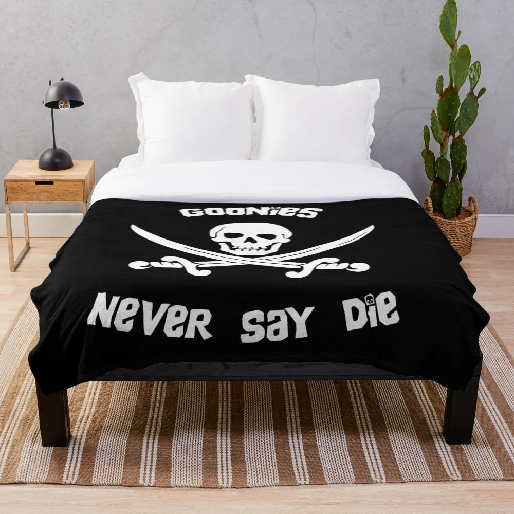Goonies-themed plush blanket with pirate skull and swords