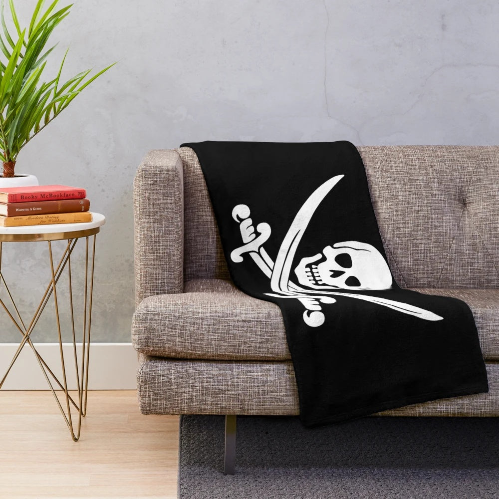Goonies-themed plush blanket with pirate skull and swords