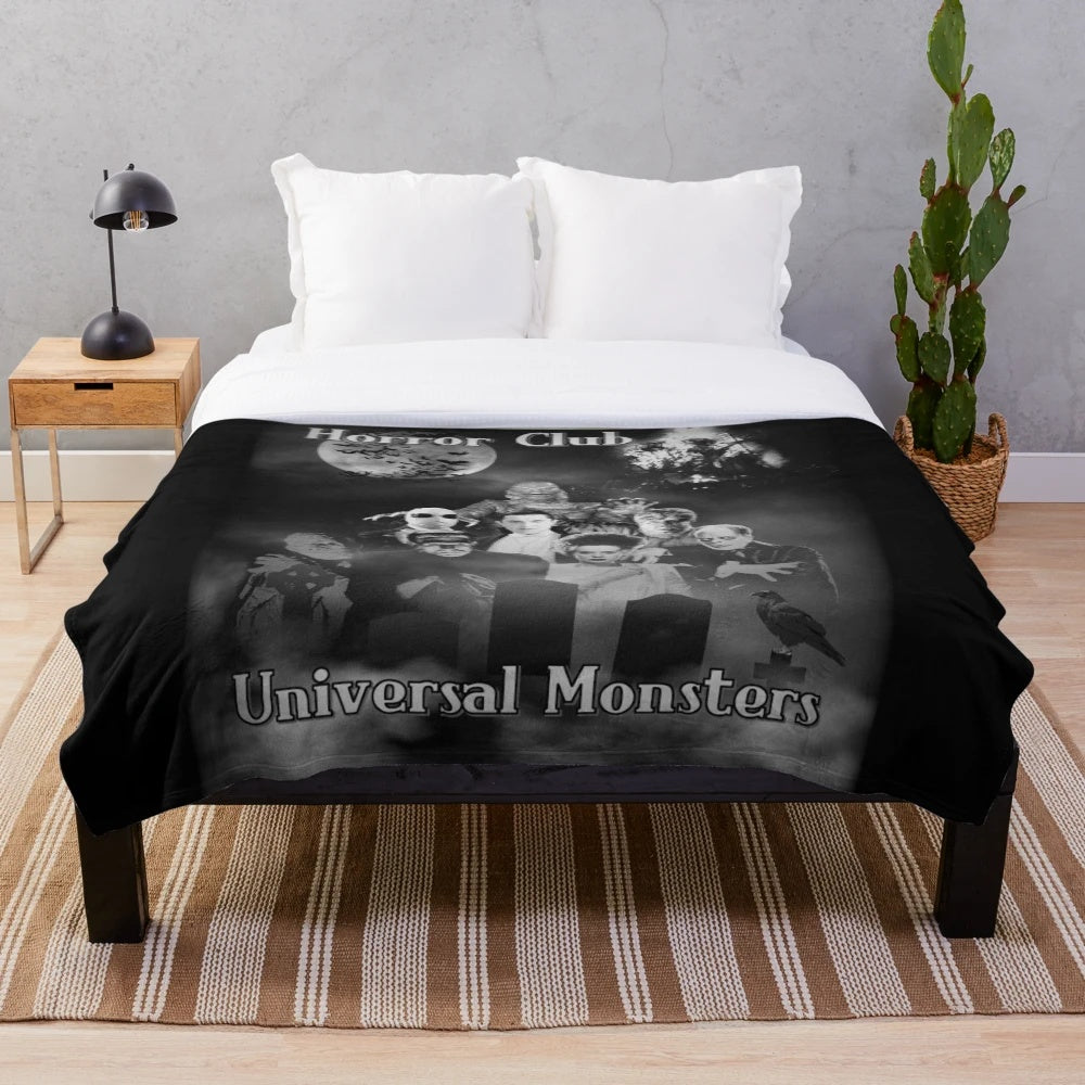 Vintage-inspired plush blanket featuring classic horror movie monsters like Frankenstein, Dracula, and the Mummy