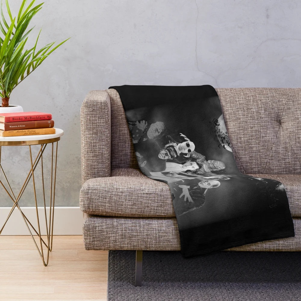 Vintage-inspired plush blanket featuring classic horror movie monsters like Frankenstein, Dracula, and the Mummy