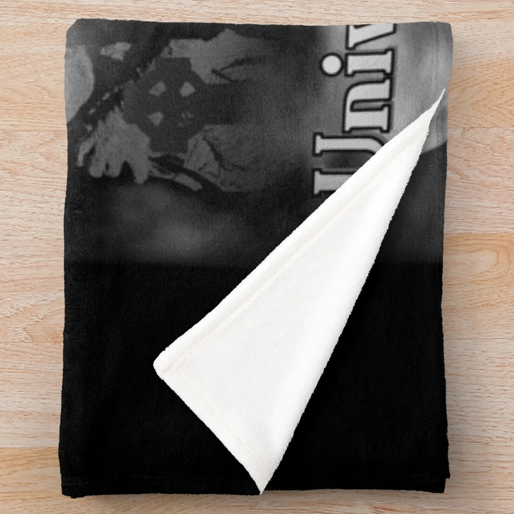 Vintage-inspired plush blanket featuring classic horror movie monsters like Frankenstein, Dracula, and the Mummy