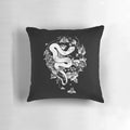 A black and white graphic illustration of a snake, moth, and flower on a 'The End of the Summer' decorative pillow for gothic and boho home decor