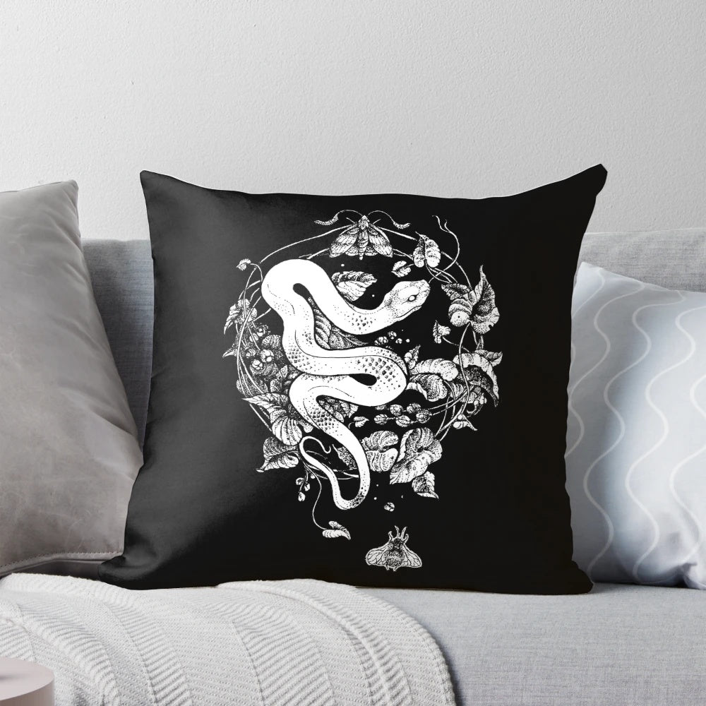 A black and white graphic illustration of a snake, moth, and flower on a 'The End of the Summer' decorative pillow for gothic and boho home decor