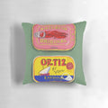 Colorful decorative pillow featuring a painting of tinned seafood like anchovies and sardines