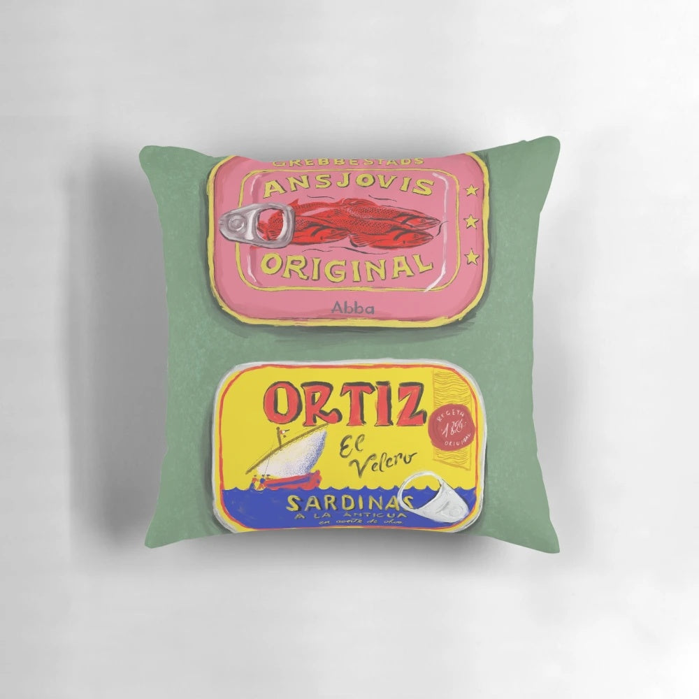 Colorful decorative pillow featuring a painting of tinned seafood like anchovies and sardines