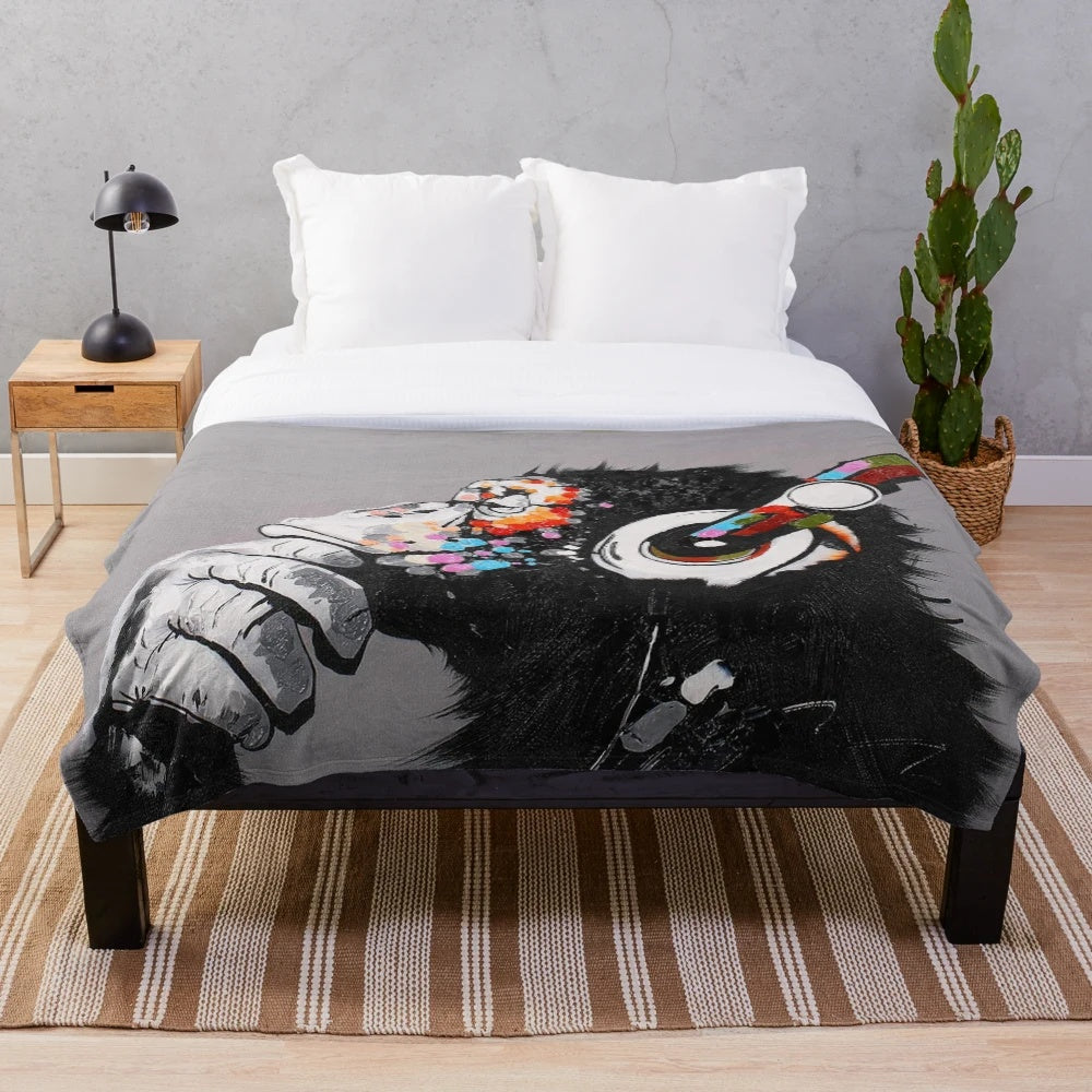 Graffiti-inspired thinker chimp plush blanket with headphones