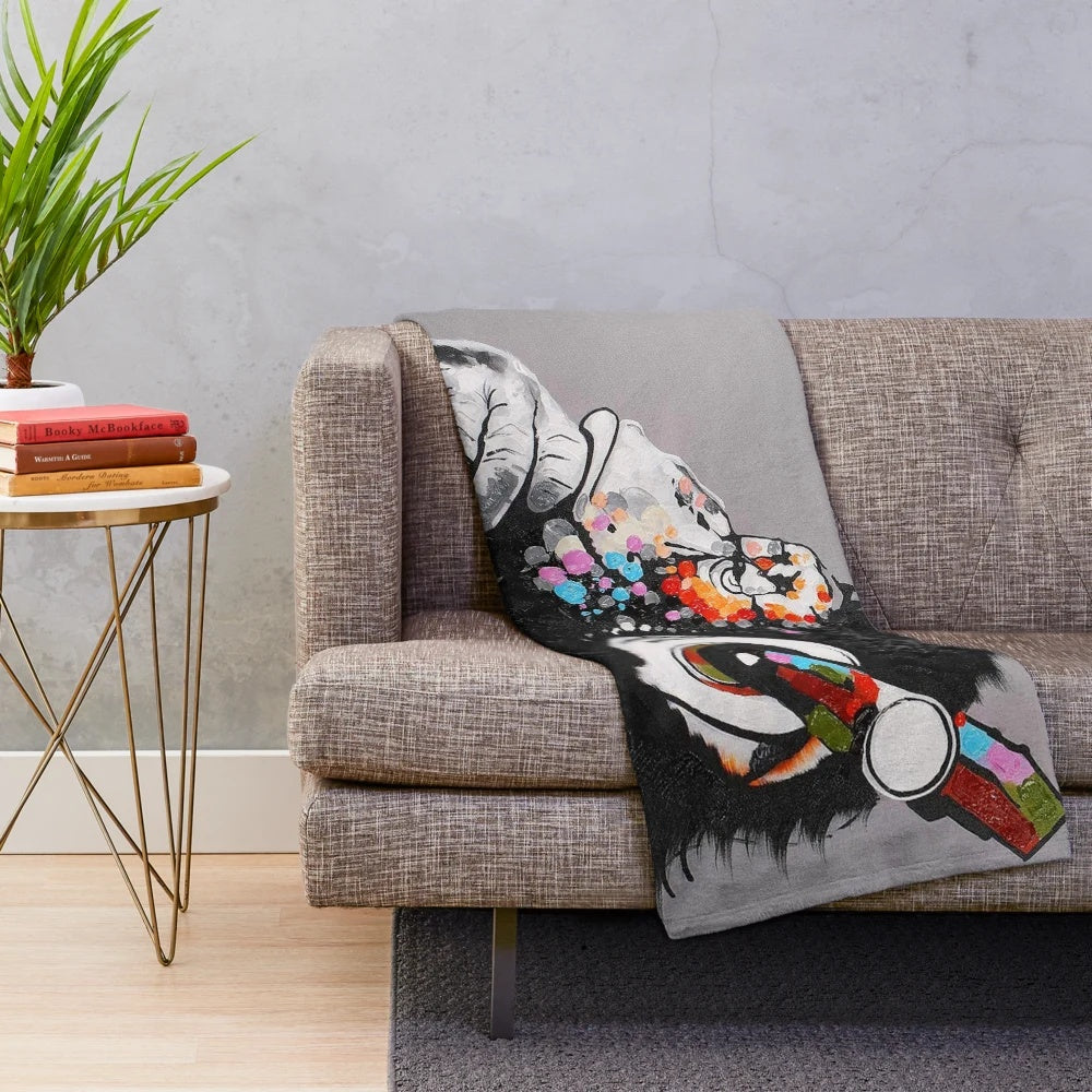 Graffiti-inspired thinker chimp plush blanket with headphones