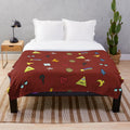 Gravity Falls inspired plush throw blanket with cartoon symbols like pine trees, shooting stars, and triangles