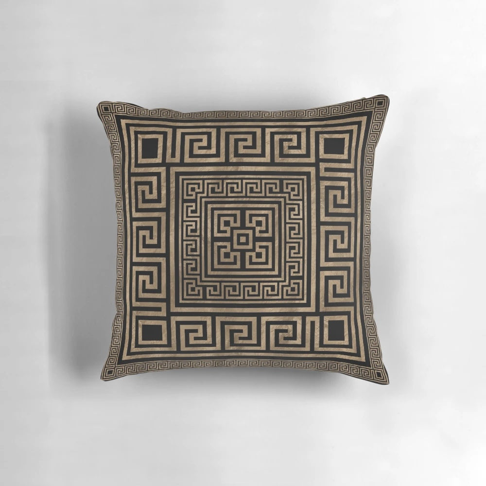 Decorative throw pillow featuring a Greek key ornament and meander pattern in gold on a black background.