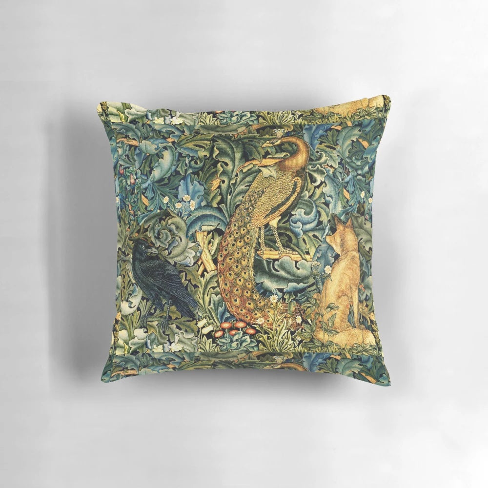 Green floral pillow featuring a vintage-inspired design with peacock, raven, and other forest animals in a lush, botanical setting.
