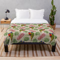 Colorful Australian plush blanket with a grevillea and rainbow lorikeet bird pattern