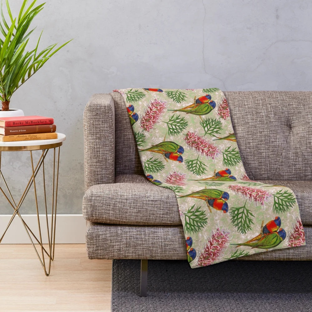 Colorful Australian plush blanket with a grevillea and rainbow lorikeet bird pattern