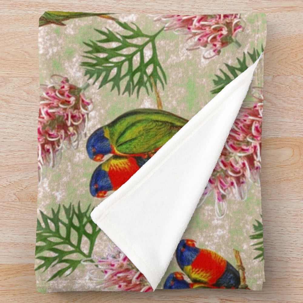 Colorful Australian plush blanket with a grevillea and rainbow lorikeet bird pattern