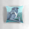 A blue and white decorative pillow featuring a greyhound or whippet breed dog design.