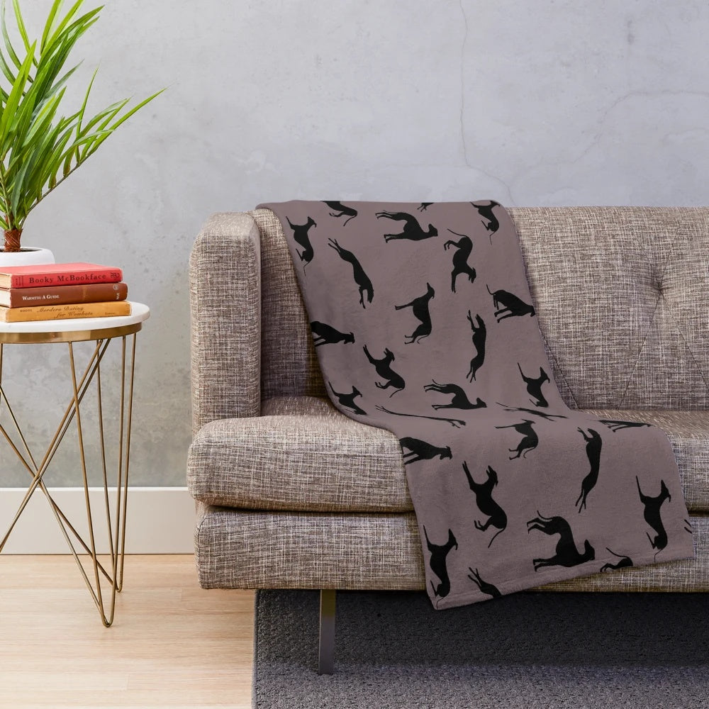 Greyhound silhouette design on a soft, plush blanket