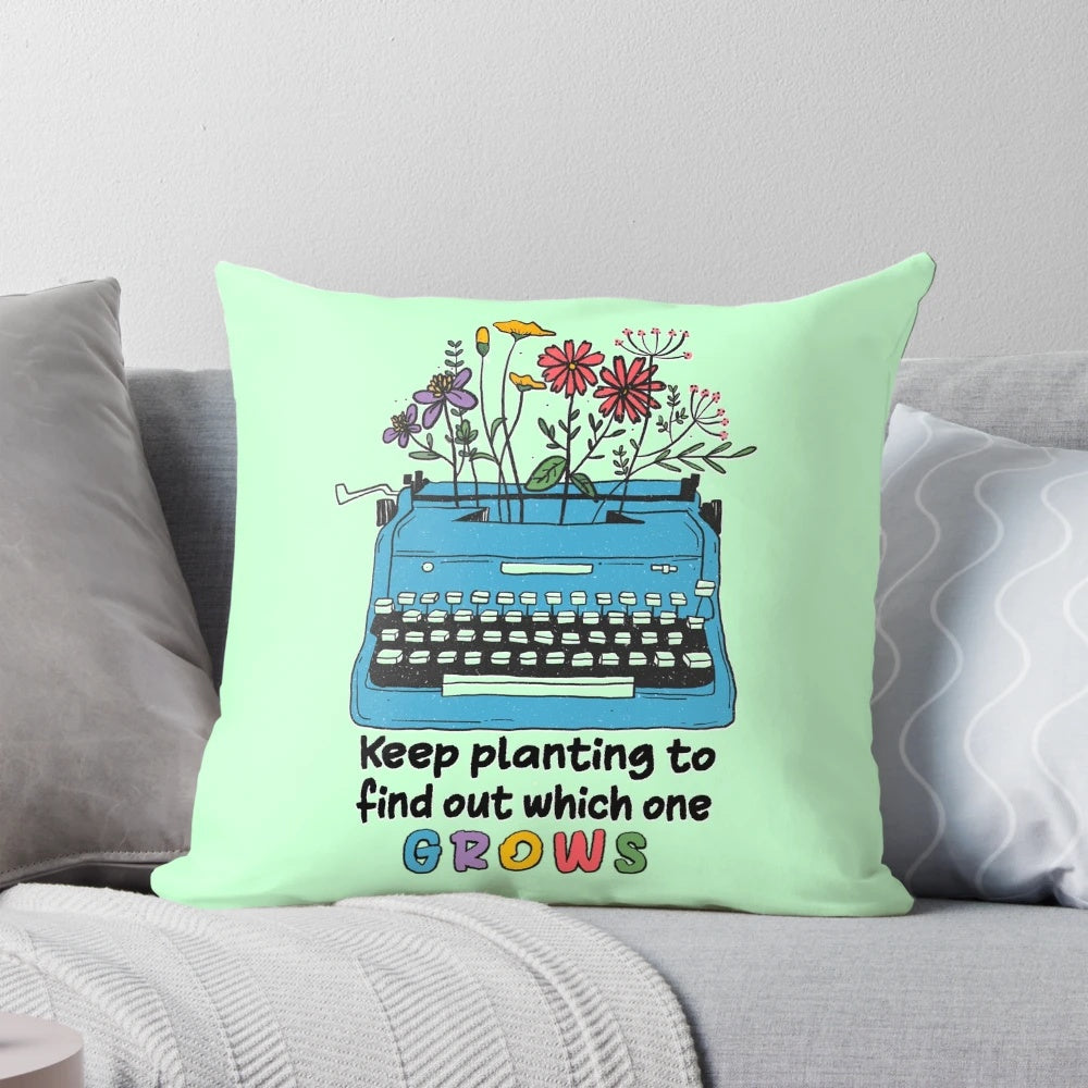 Keep Planting to Find Out Which One Grows" Pillow featuring a typewriter and plant design