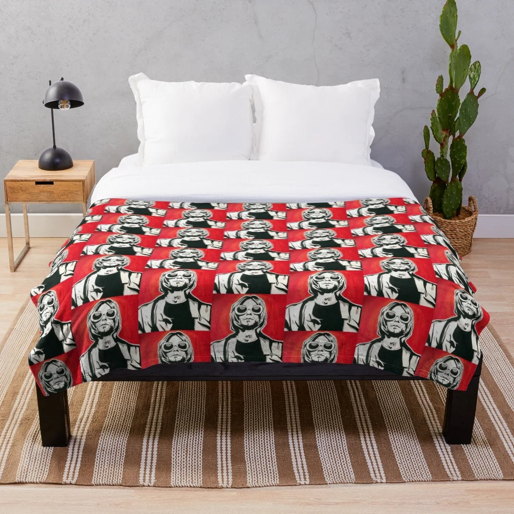Plush blanket with a pop art-inspired Kurt Cobain design