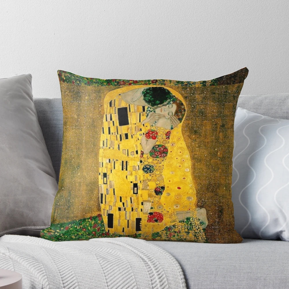 A beautiful decorative pillow featuring Gustav Klimt's iconic painting "The Kiss" depicting a couple in a loving embrace.