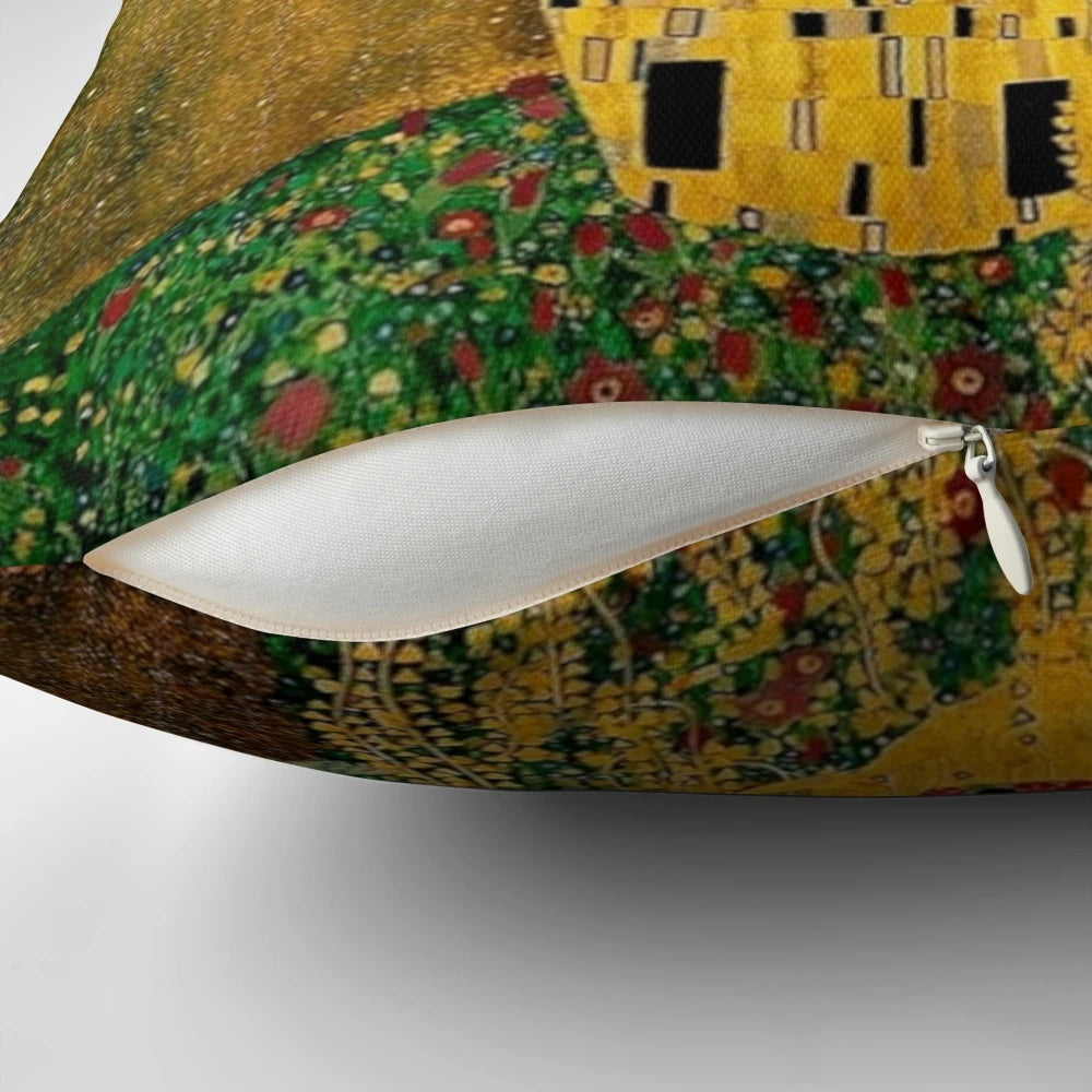A beautiful decorative pillow featuring Gustav Klimt's iconic painting "The Kiss" depicting a couple in a loving embrace.