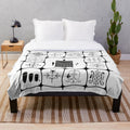 Haitian inspired plush blanket with voodoo symbols and Kesler Pierre art