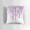 A vibrant hand-painted purple wisteria floral design on a pillow cover.