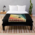 Handball player's plush blanket with retro handball ball design