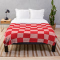 Handcrafted checkered plush blanket in pink and red tones