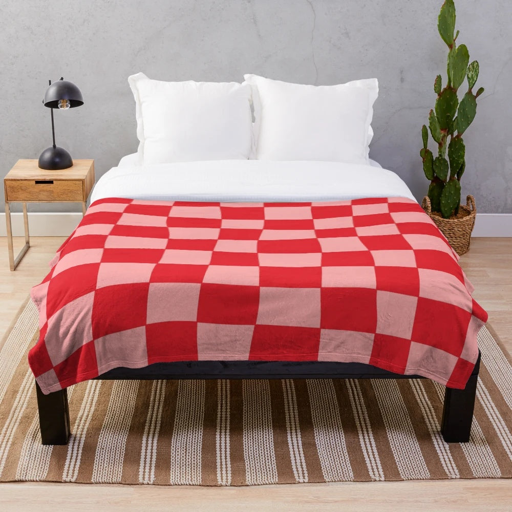 Handcrafted checkered plush blanket in pink and red tones