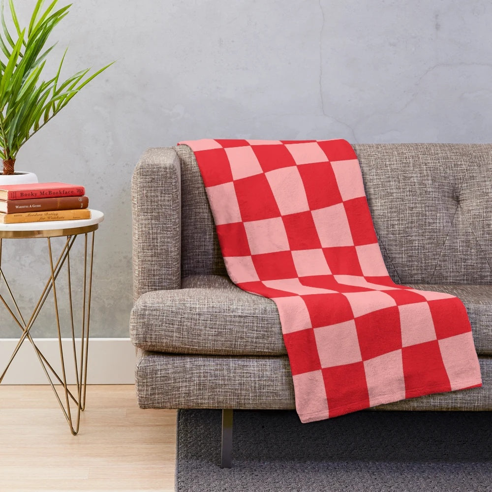 Handcrafted checkered plush blanket in pink and red tones