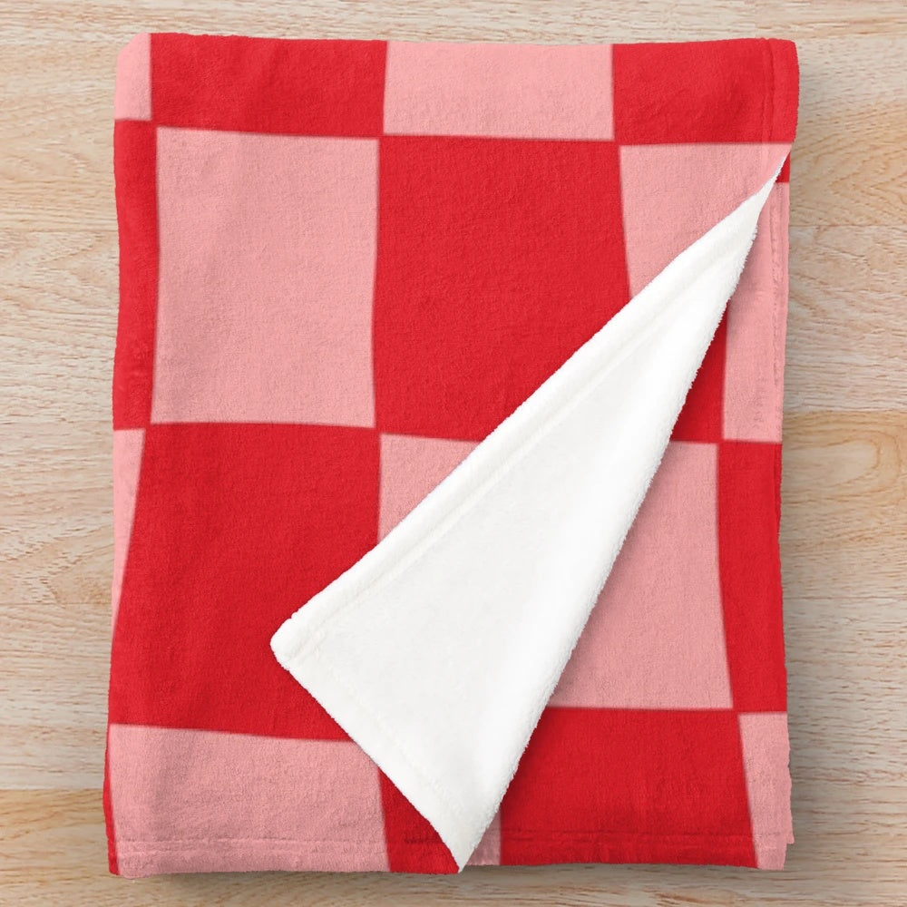Handcrafted checkered plush blanket in pink and red tones