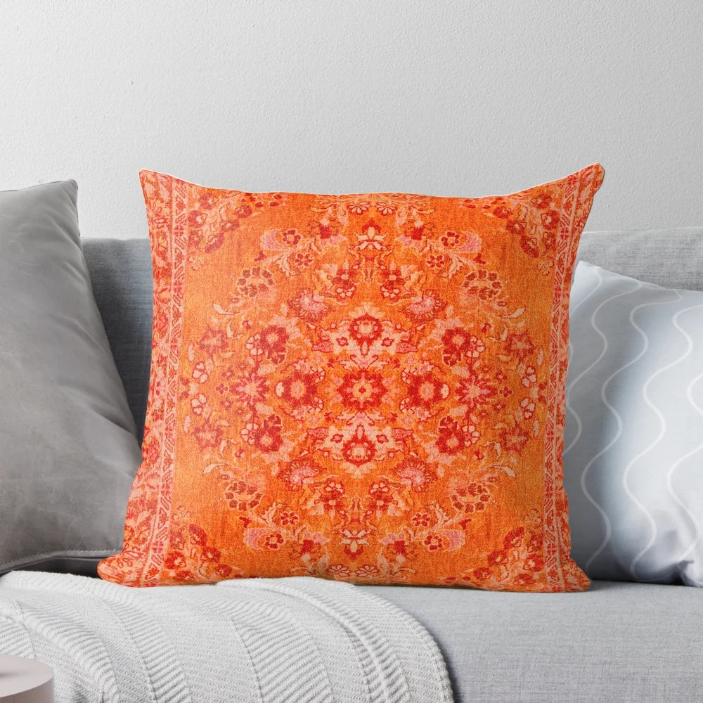 Closeup of a vibrant orange and blue patterned Moroccan-style bohemian throw pillow