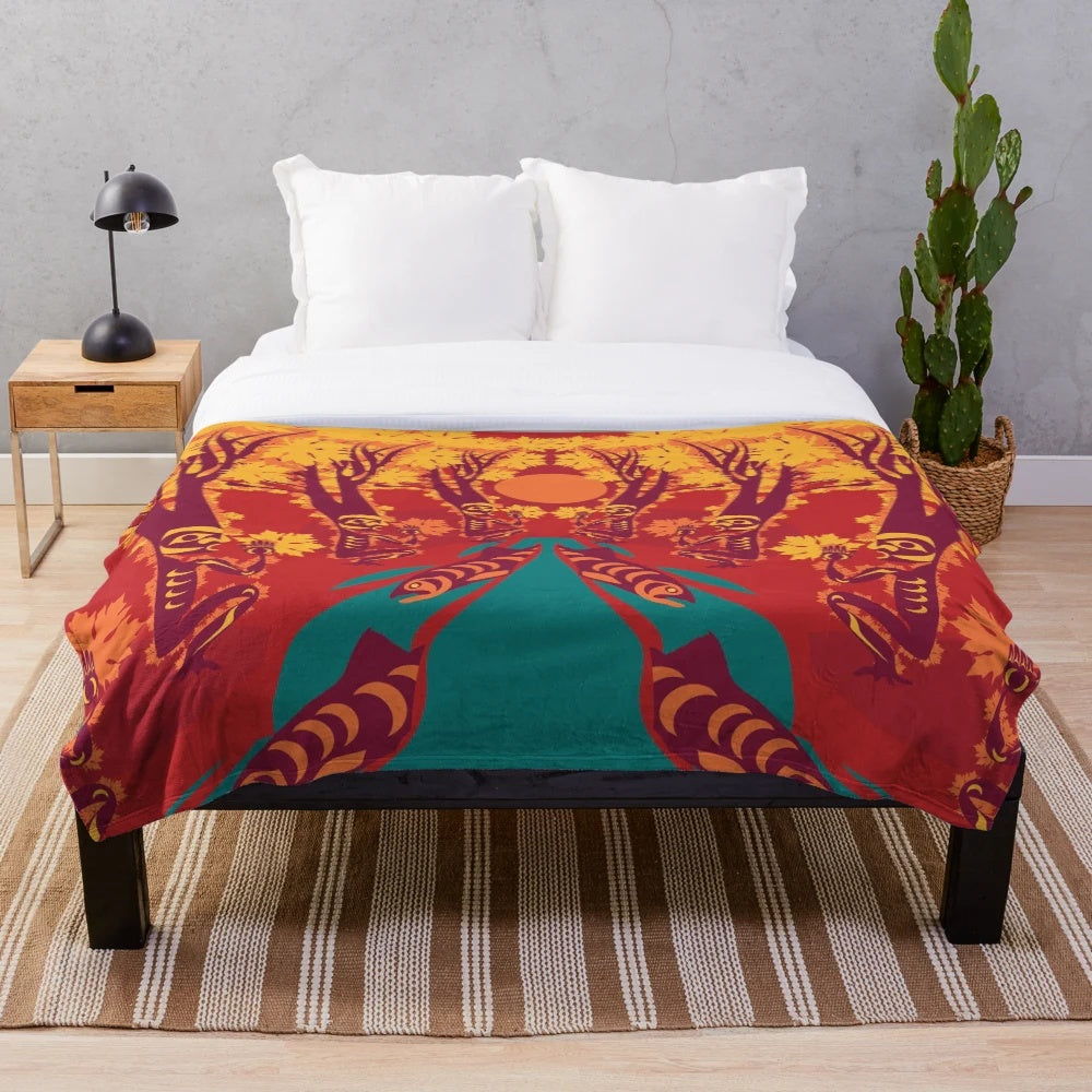 Coast Salish-inspired plush blanket with maple, salmon, and forest motifs