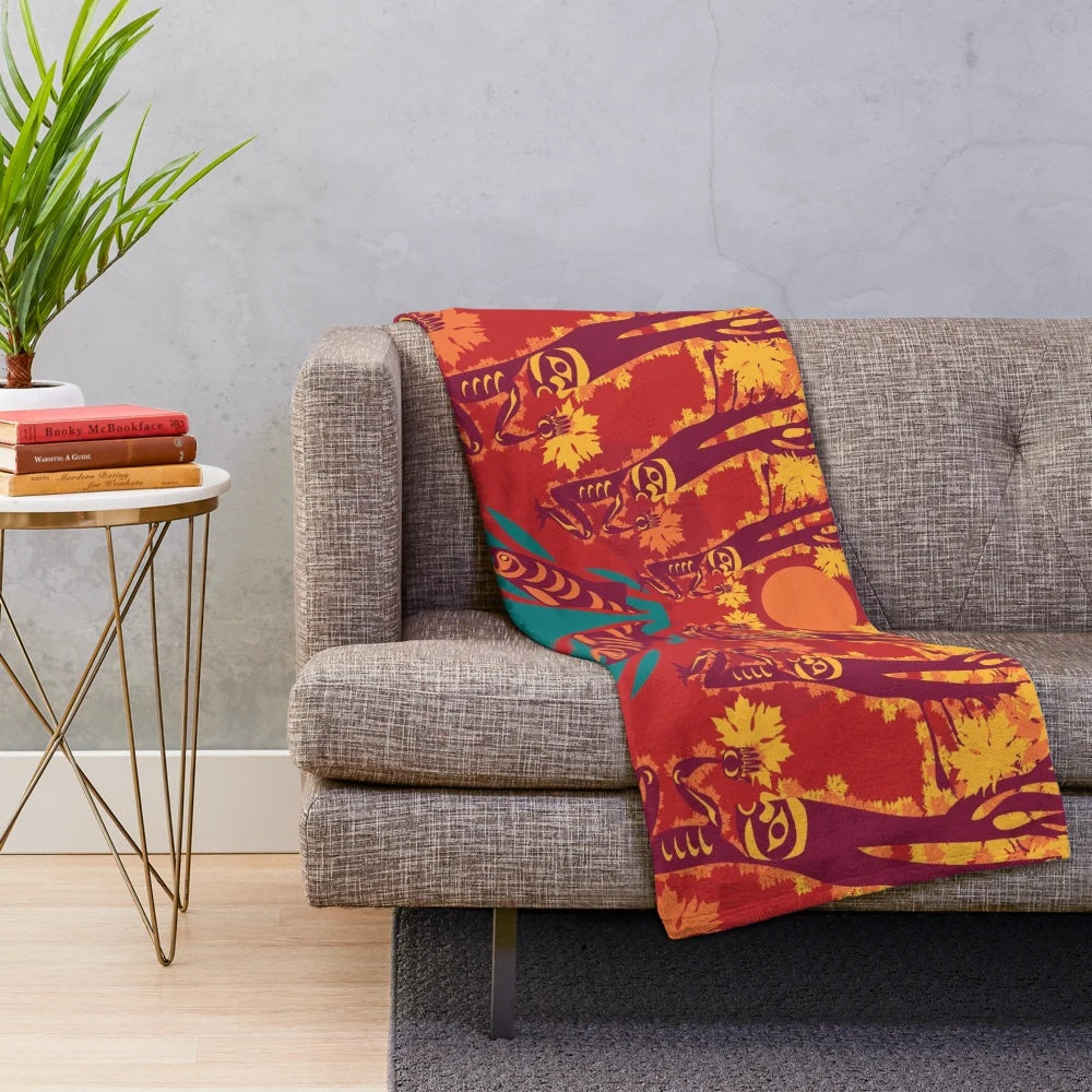 Coast Salish-inspired plush blanket with maple, salmon, and forest motifs