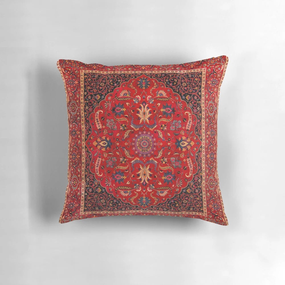 Closeup of a vibrant red Persian-style area rug pillow with intricate floral and geometric patterns.