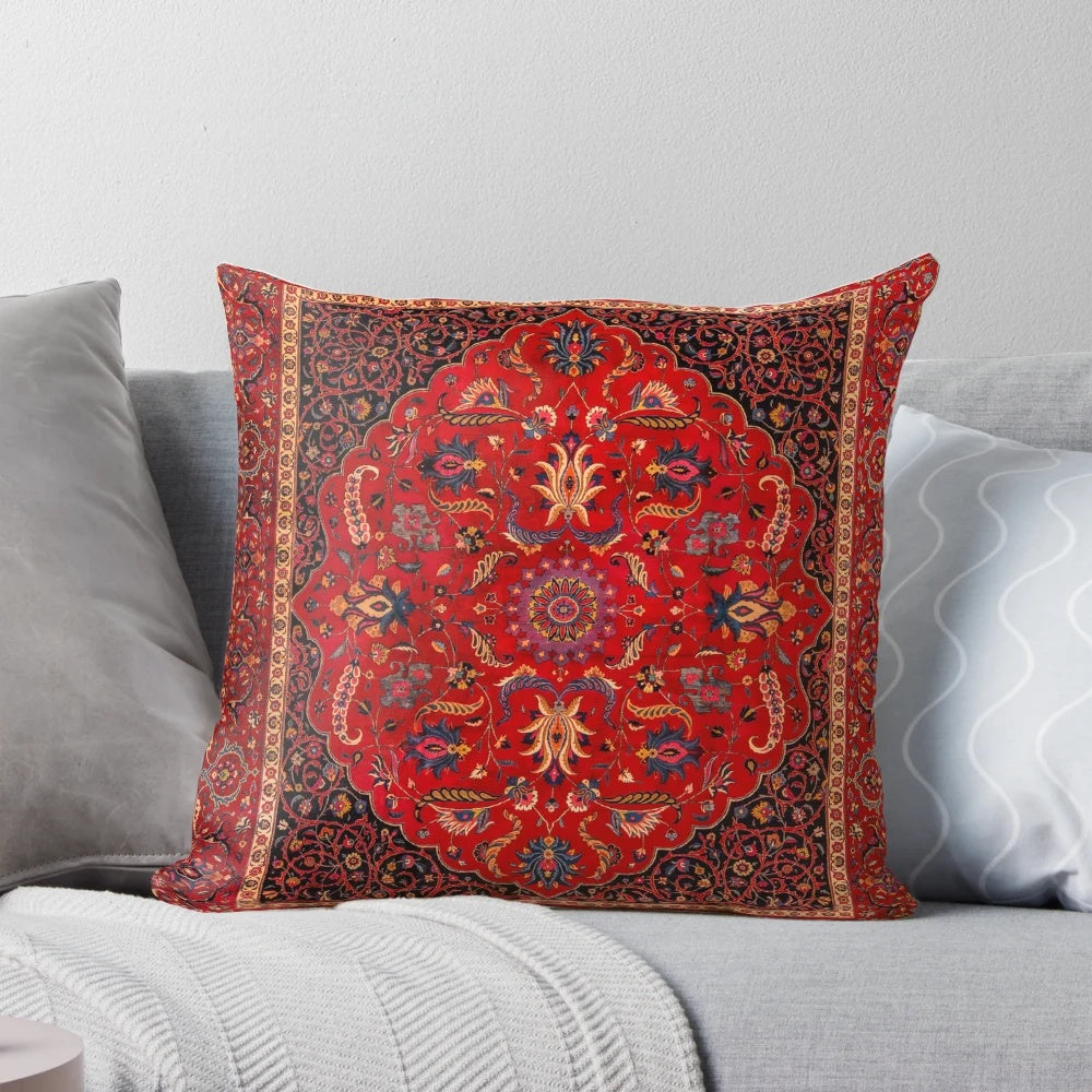 Closeup of a vibrant red Persian-style area rug pillow with intricate floral and geometric patterns.