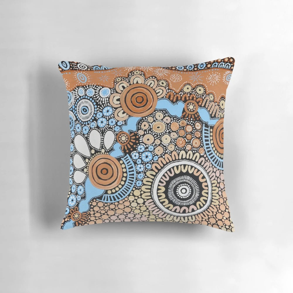 Handmade pillow featuring authentic indigenous dot painting art inspired by the river landscape