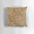 Closeup of a decorative straw and hay pillow with a natural, rustic pattern