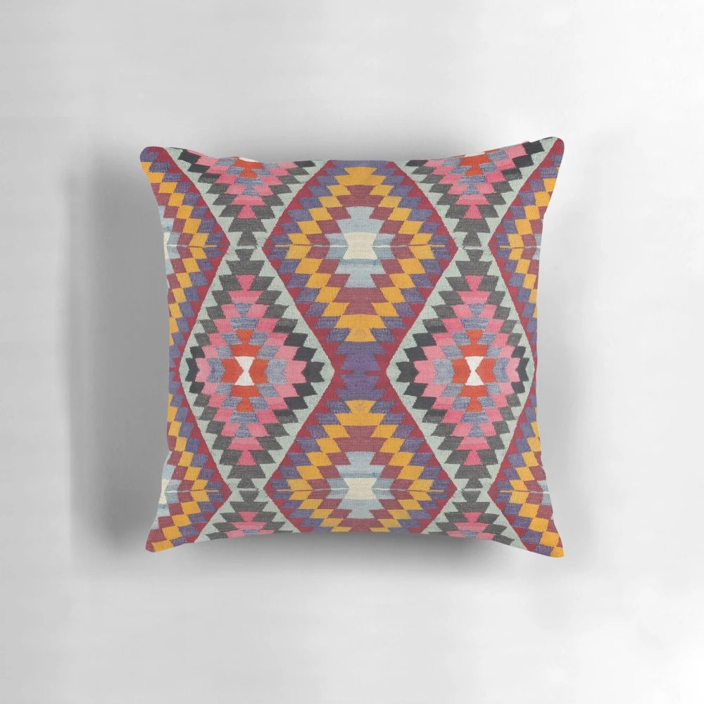 Closeup of a vibrant, multicolored Turkish kilim pattern pillow.