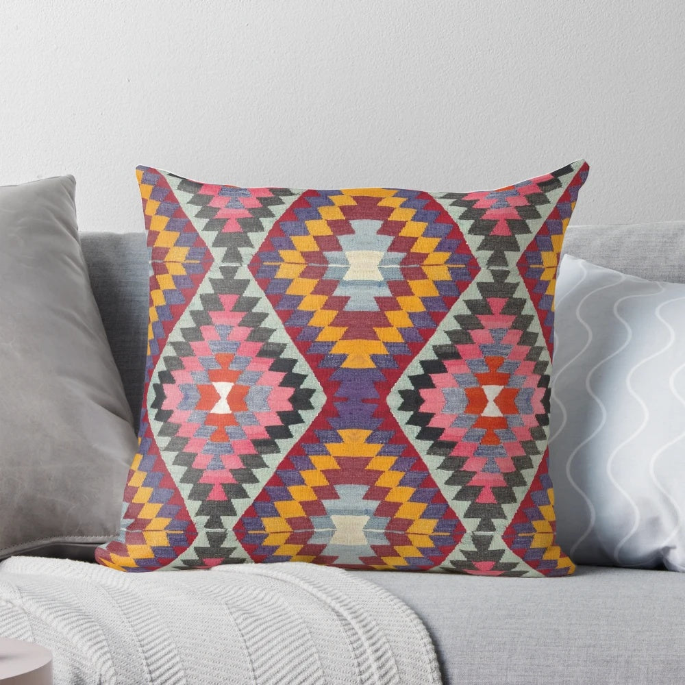 Closeup of a vibrant, multicolored Turkish kilim pattern pillow.