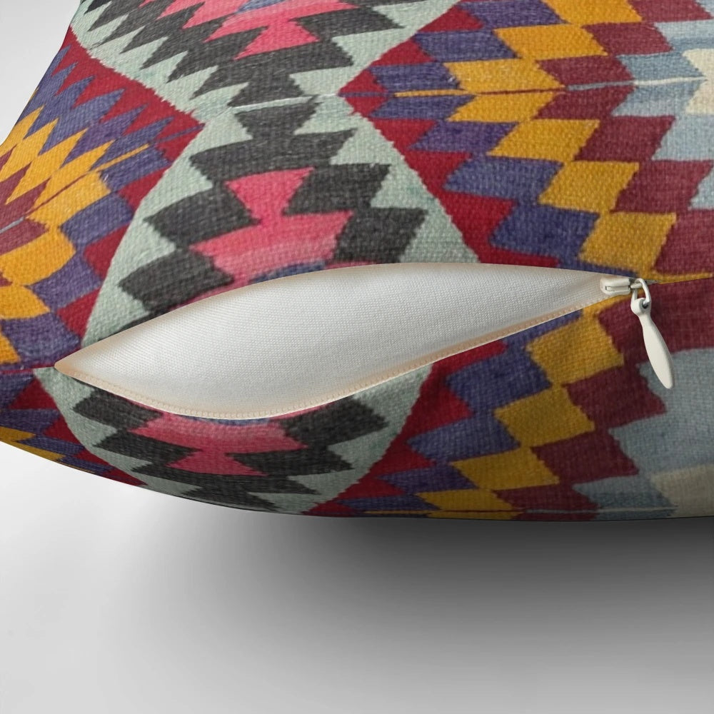 Closeup of a vibrant, multicolored Turkish kilim pattern pillow.