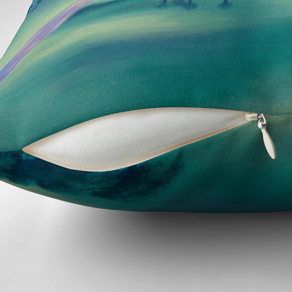 Close-up of a vibrant, abstract geometric pillow in shades of blue, pink, and white.